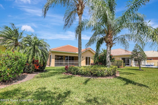 mediterranean / spanish house with a front lawn