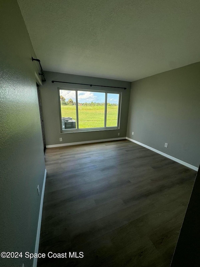 spare room featuring dark hardwood / wood-style floors