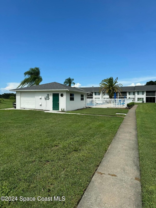 ranch-style house with a front yard and a garage