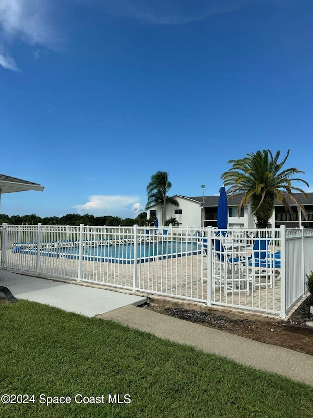 view of pool featuring a patio and a water view