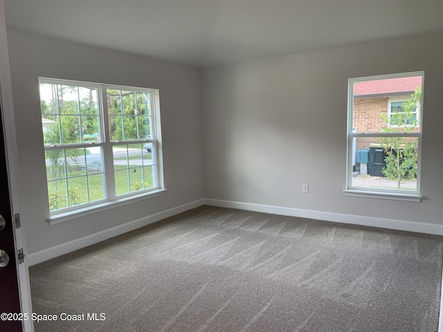 439 Wellwood St SW, Palm Bay, FL 32908 - spare room featuring dark colored carpet and baseboards