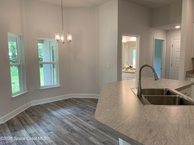 439 Wellwood St SW, Palm Bay, FL 32908 - kitchen featuring a chandelier, dark wood finished floors, decorative light fixtures, light countertops, and white cabinets