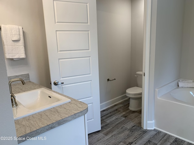 439 Wellwood St SW, Palm Bay, FL 32908 - bathroom featuring a bath, wood finished floors, and vanity