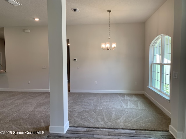 439 Wellwood St SW, Palm Bay, FL 32908 - carpeted empty room featuring a chandelier and a textured ceiling
