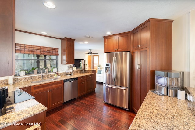 kitchen featuring light stone countertops, sink, dark hardwood / wood-style floors, and appliances with stainless steel finishes