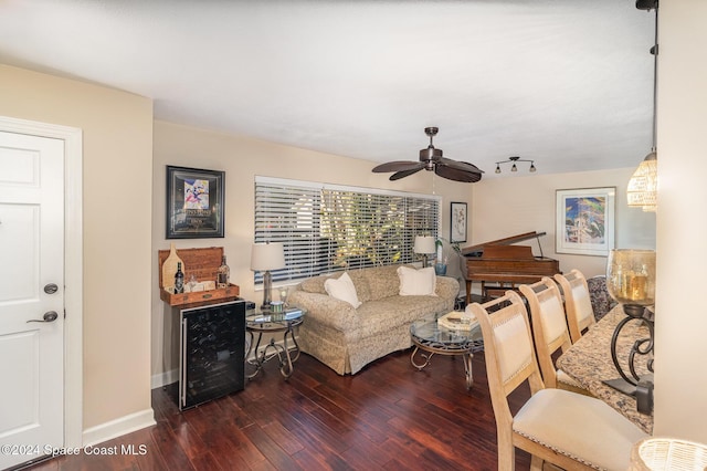 living room with dark hardwood / wood-style floors, ceiling fan, and beverage cooler