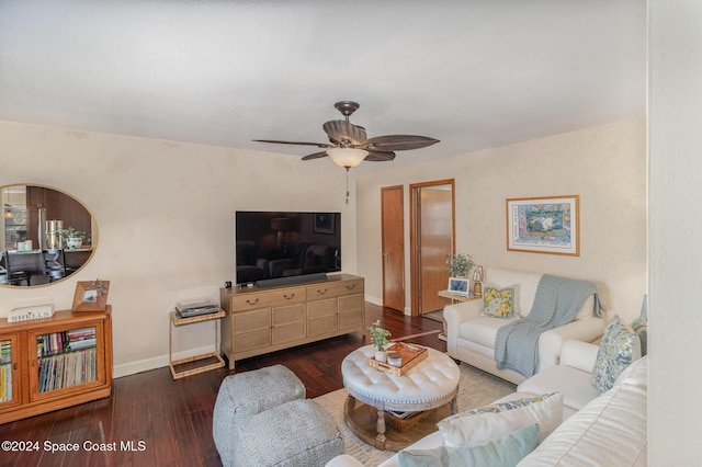 living room featuring ceiling fan and dark hardwood / wood-style flooring