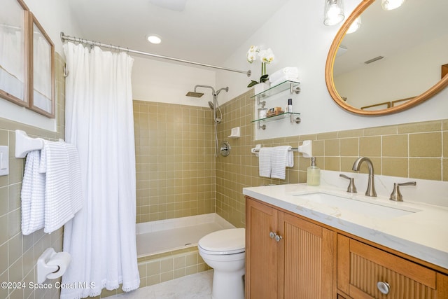 bathroom with a shower with shower curtain, vanity, toilet, and tile walls