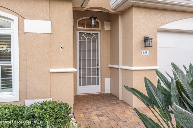 view of exterior entry featuring a garage