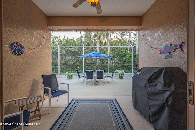 view of patio / terrace featuring ceiling fan, area for grilling, and a lanai