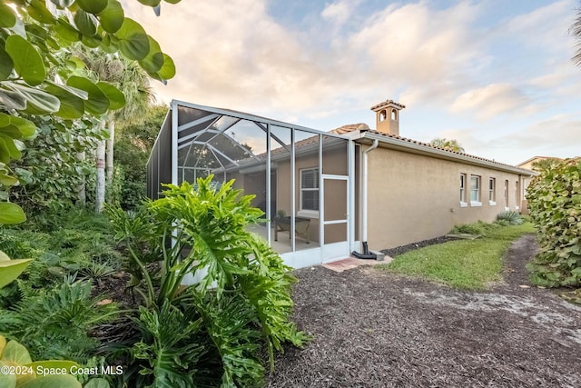 back of property with glass enclosure