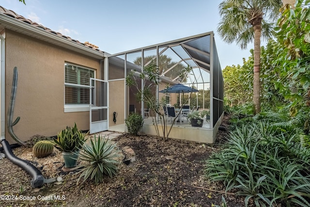 back of property with a lanai