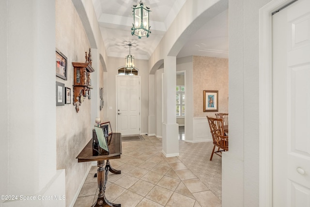 foyer entrance featuring a notable chandelier and light tile patterned flooring