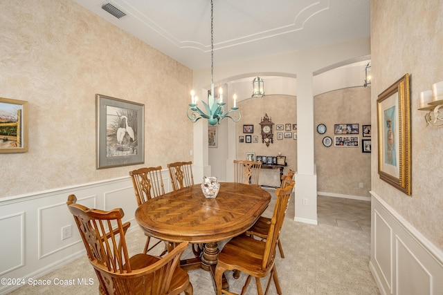 tiled dining space with a notable chandelier