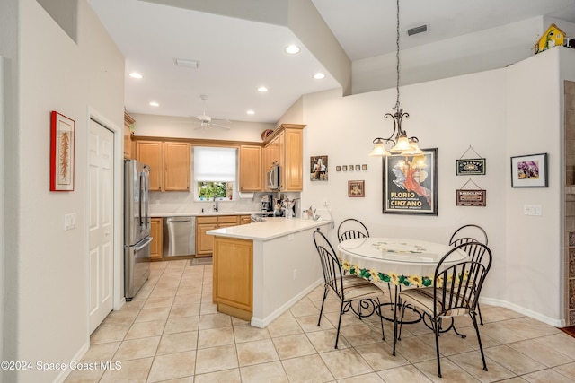 kitchen featuring ceiling fan, kitchen peninsula, stainless steel appliances, and light tile patterned floors