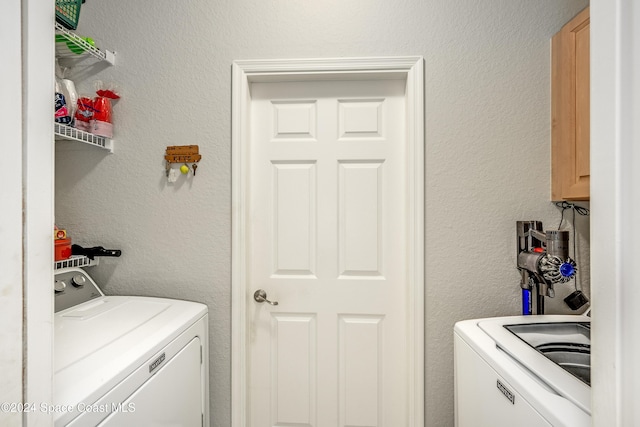 clothes washing area with washer and dryer