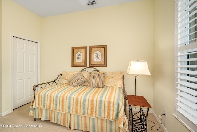 carpeted bedroom with a closet