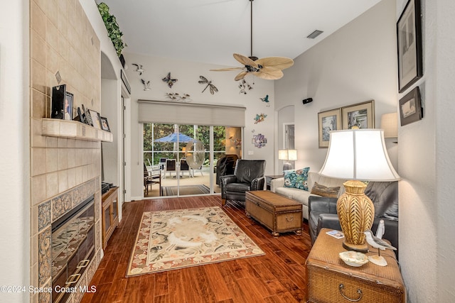 living room featuring ceiling fan and dark wood-type flooring