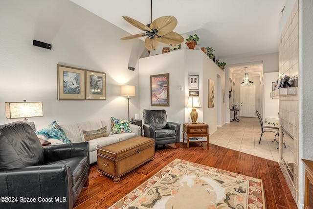 living room featuring hardwood / wood-style flooring, high vaulted ceiling, and ceiling fan