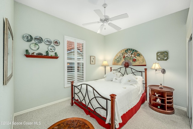 carpeted bedroom featuring a closet and ceiling fan