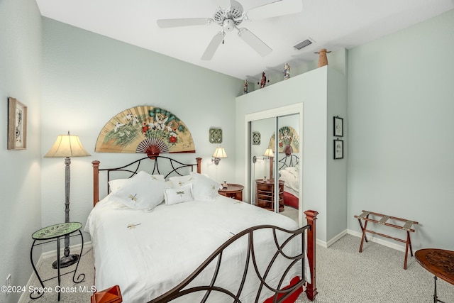 bedroom featuring ceiling fan, a closet, and light carpet