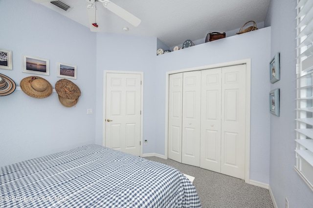 carpeted bedroom with ceiling fan and a closet