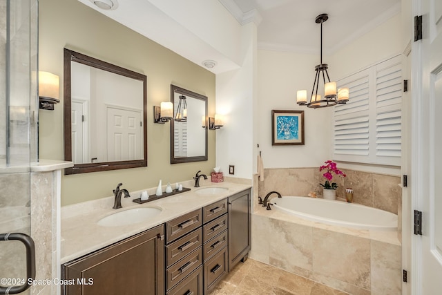 bathroom featuring a notable chandelier, vanity, ornamental molding, and tiled bath