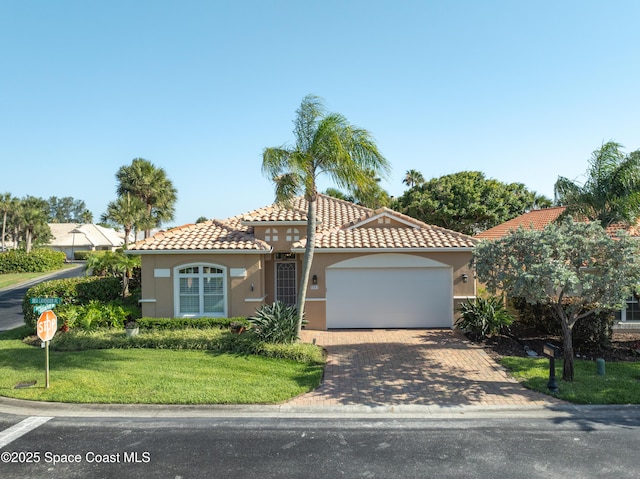 5601 Sea Lavender Pl, Melbourne Beach, FL 32951 - mediterranean / spanish-style house featuring stucco siding, a garage, a tile roof, and a front lawn