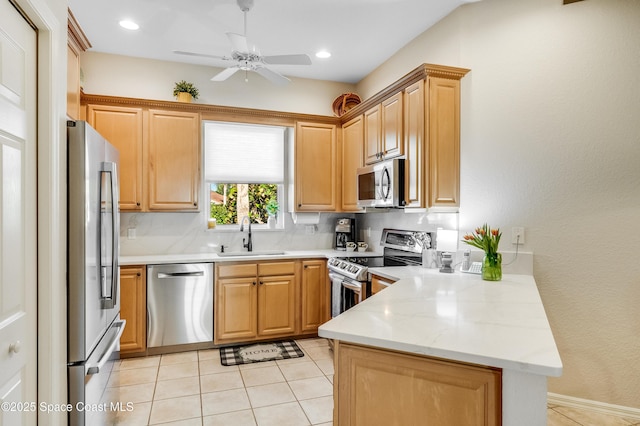 5601 Sea Lavender Pl, Melbourne Beach, FL 32951 - kitchen with appliances with stainless steel finishes, a sink, a peninsula, a ceiling fan, and backsplash