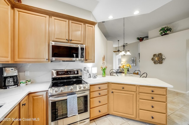 5601 Sea Lavender Pl, Melbourne Beach, FL 32951 - kitchen featuring appliances with stainless steel finishes, light tile patterned flooring, a peninsula, light countertops, and recessed lighting
