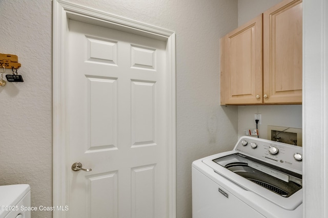 5601 Sea Lavender Pl, Melbourne Beach, FL 32951 - laundry area featuring washer / dryer, cabinet space, and a textured wall