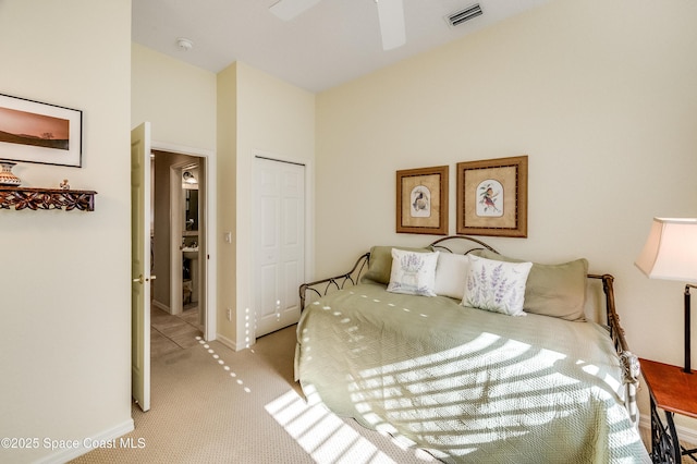 5601 Sea Lavender Pl, Melbourne Beach, FL 32951 - bedroom featuring a closet, light carpet, baseboards, and ceiling fan