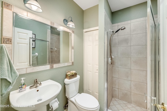 5601 Sea Lavender Pl, Melbourne Beach, FL 32951 - bathroom featuring a stall shower, a sink, toilet, and a closet