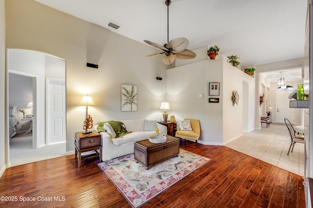 5601 Sea Lavender Pl, Melbourne Beach, FL 32951 - living area featuring arched walkways, ceiling fan, light wood-type flooring, baseboards, and high vaulted ceiling
