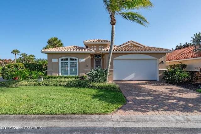 5601 Sea Lavender Pl, Melbourne Beach, FL 32951 - mediterranean / spanish home featuring stucco siding, an attached garage, decorative driveway, and a front yard