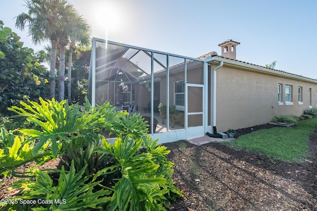 5601 Sea Lavender Pl, Melbourne Beach, FL 32951 - back of property featuring stucco siding and a lanai