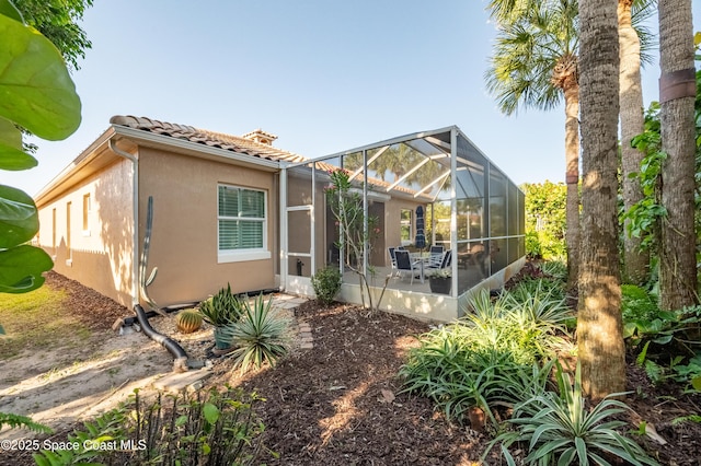 5601 Sea Lavender Pl, Melbourne Beach, FL 32951 - rear view of property with a tiled roof, a patio area, stucco siding, and a lanai