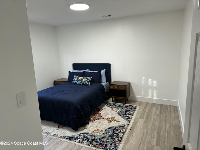 bedroom with wood-type flooring