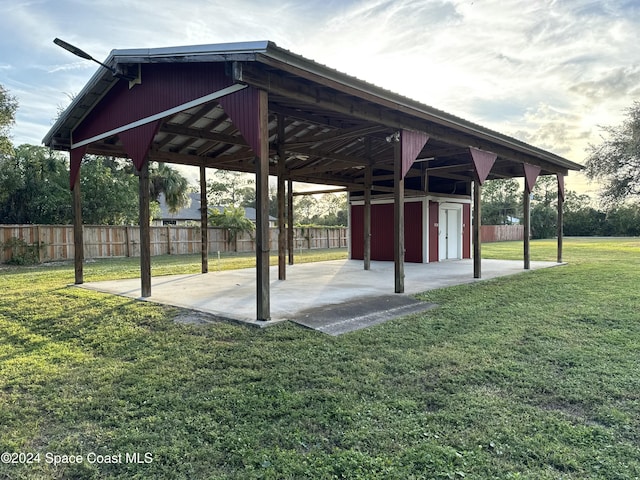 view of home's community featuring a lawn and a storage unit