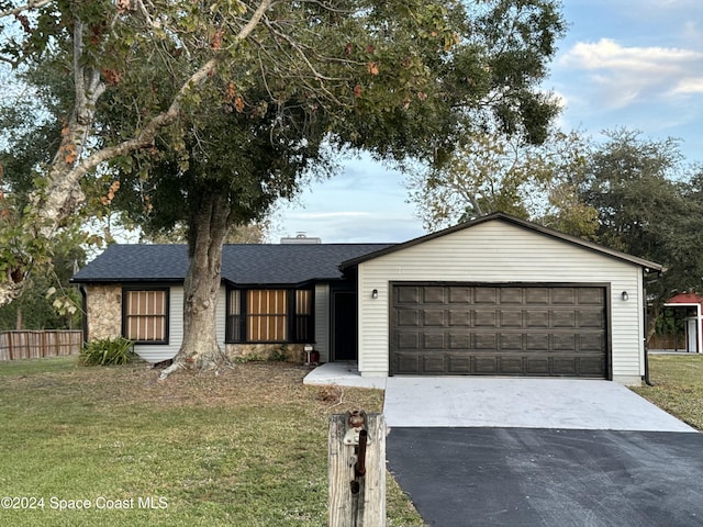 view of front of property with a front lawn and a garage