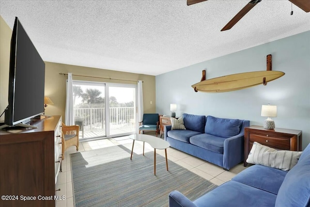 tiled living room with ceiling fan and a textured ceiling