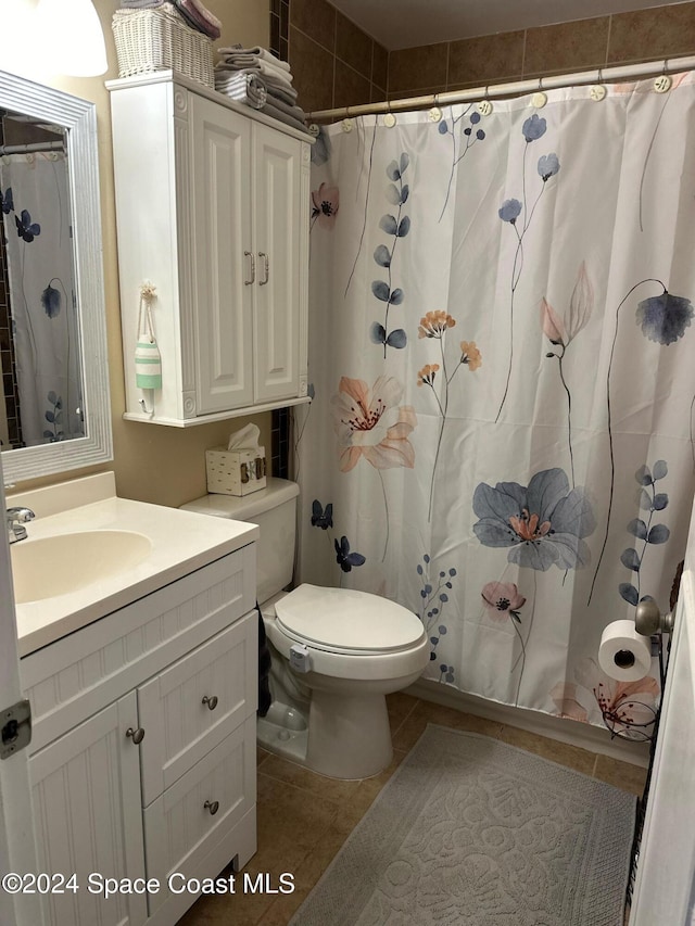 bathroom featuring tile patterned flooring, vanity, a shower with shower curtain, and toilet