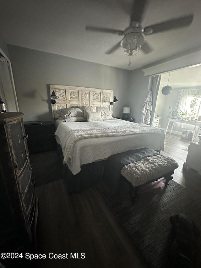 bedroom featuring access to exterior, wood-type flooring, and ceiling fan