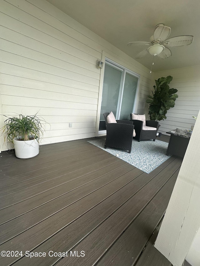 wooden deck featuring an outdoor hangout area and ceiling fan