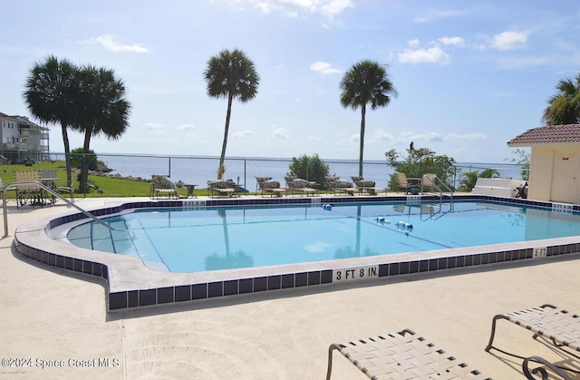 view of swimming pool with a water view