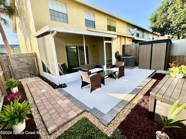 rear view of house featuring an outdoor hangout area, a patio, and central AC unit