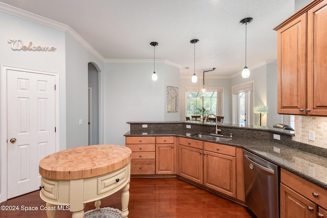 kitchen featuring sink, stainless steel dishwasher, dark stone countertops, decorative light fixtures, and kitchen peninsula