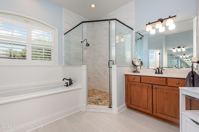 bathroom with vanity and independent shower and bath