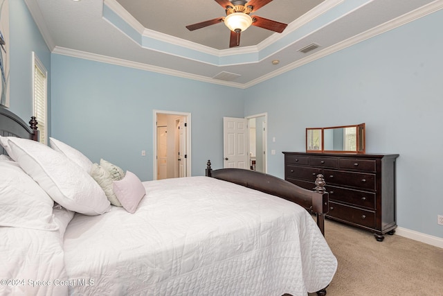 carpeted bedroom with ceiling fan, ornamental molding, and a tray ceiling