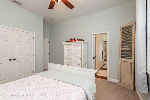 bedroom featuring ceiling fan, a closet, and light carpet